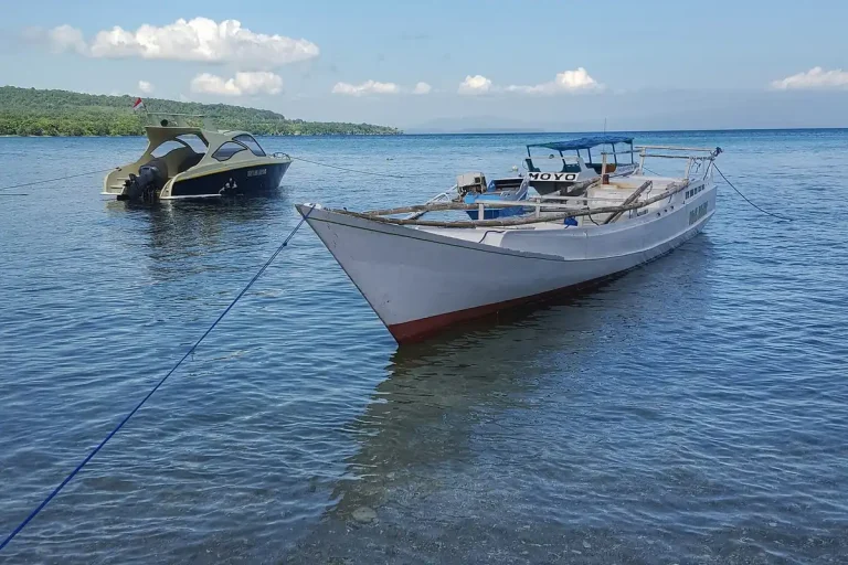 Two wooden boats moored in calm water off Sumbawa
