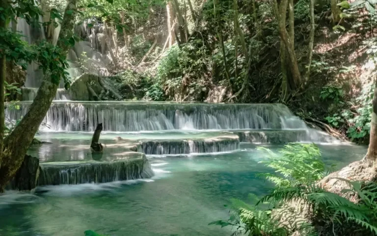 Mata Jitu waterfall cascading into turquoise pools on Moyo Island