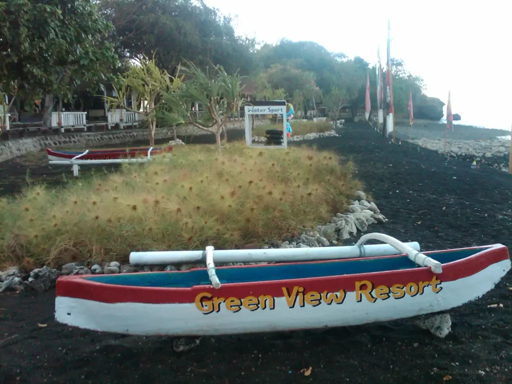 Outrigger boat on the black-sand beach at Sentigi, Sumbawa