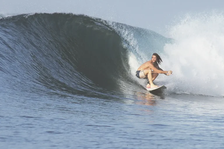 Surfer riding a barrel wave in Sumbawa